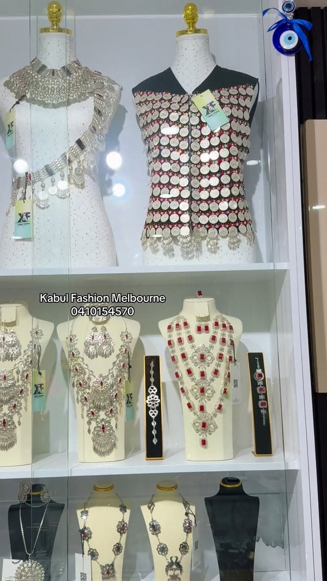 Lapis Hazaragi Two-Piece — Afghan dress from Kabul Fashion Melbourne, showing jewelry, display case, mannequin.
