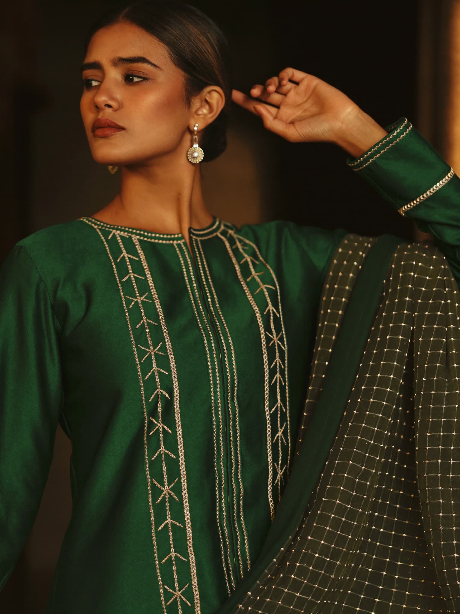 Emerald dress with gold hand embroidery, styled by Kabul Fashion.